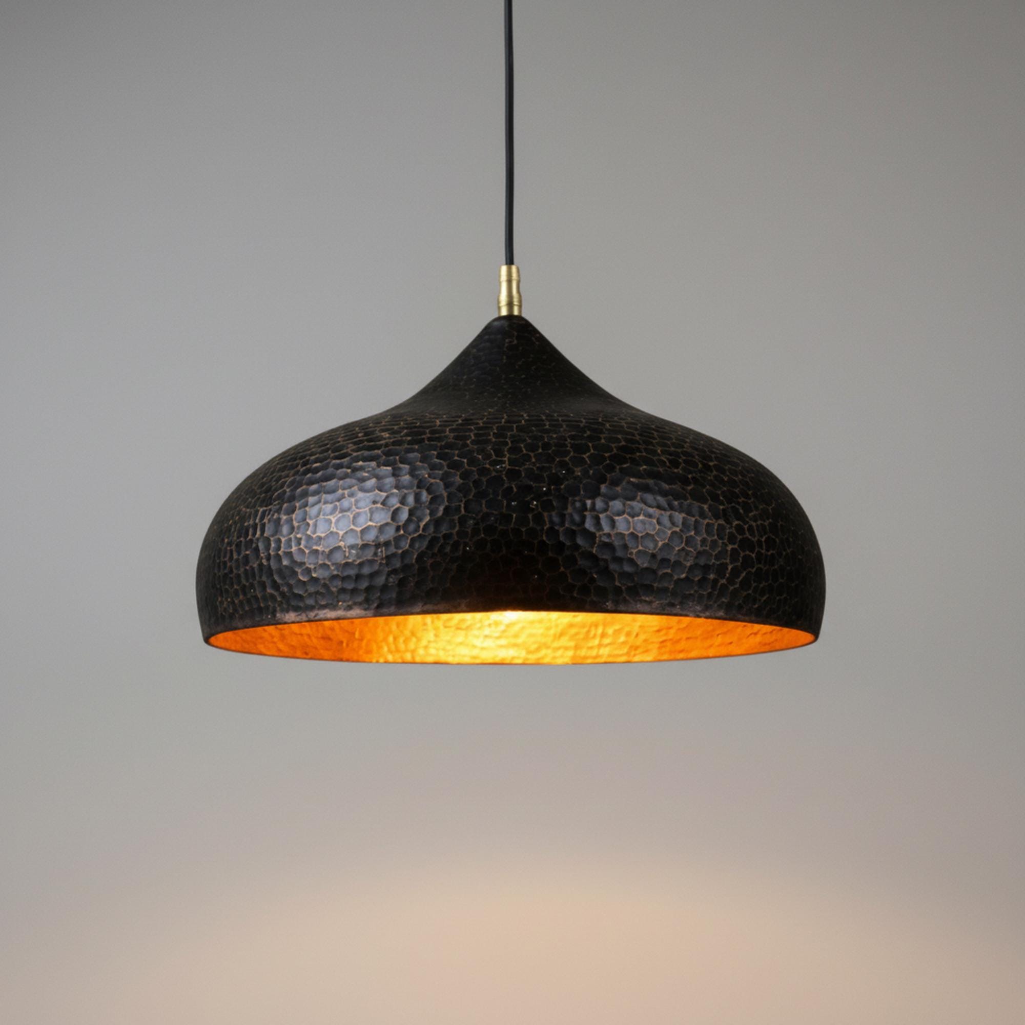 Handmade brass hanging light with hammered dome shade and warm gold interior